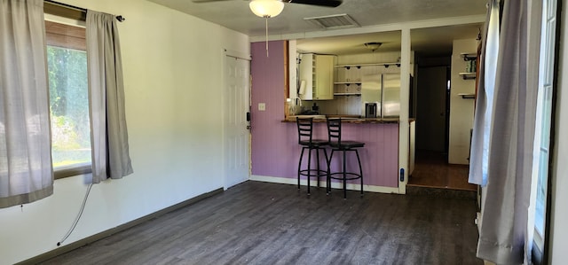 510 S Elm St, Colville, WA 99114 - kitchen featuring stainless steel refrigerator with ice dispenser, dark wood-style floors, a ceiling fan, and plenty of natural light
