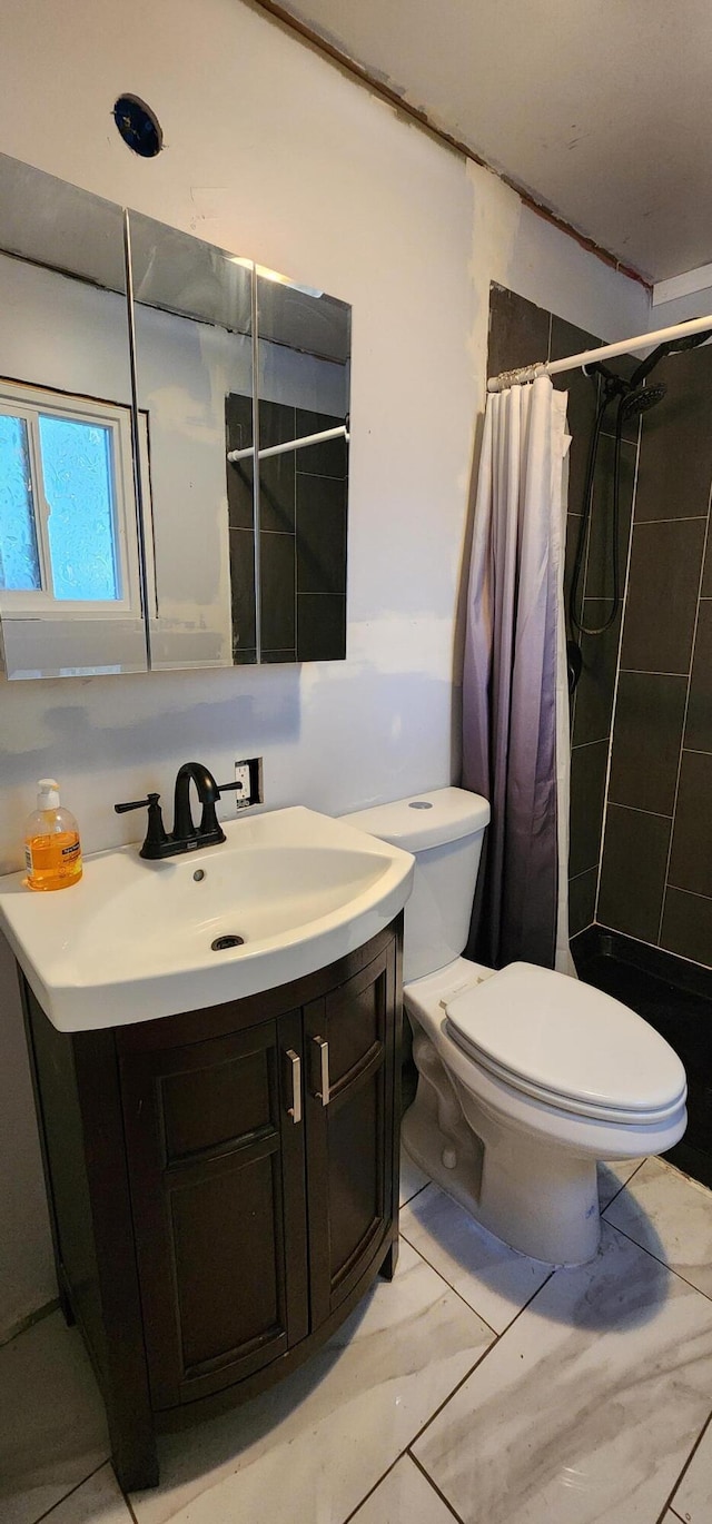 510 S Elm St, Colville, WA 99114 - full bathroom featuring toilet, vanity, marble finish flooring, and tiled shower