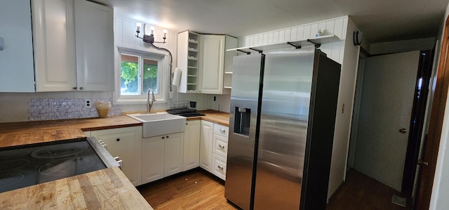 510 S Elm St, Colville, WA 99114 - kitchen with stainless steel fridge with ice dispenser, wooden counters, a sink, tasteful backsplash, and white cabinetry