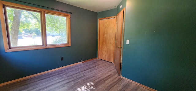 510 S Elm St, Colville, WA 99114 - unfurnished bedroom featuring multiple windows, wood finished floors, and baseboards