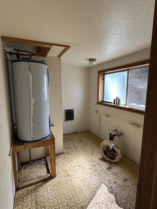 3928 Cedar Creek Rd, Colville, WA 99114 - bathroom featuring water heater, a textured ceiling, and tile patterned floors