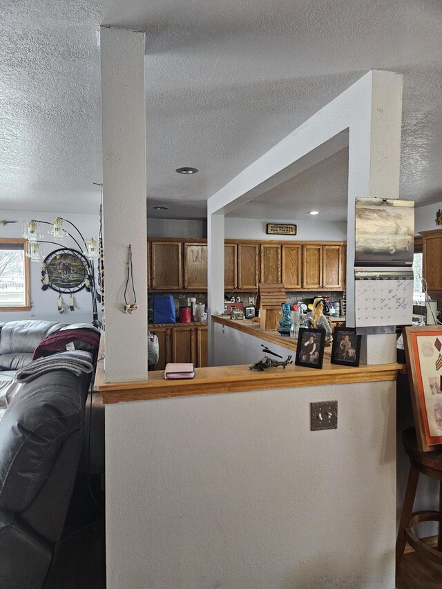 kitchen with a textured ceiling and kitchen peninsula