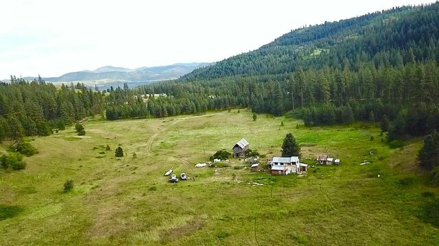 drone / aerial view featuring a mountain view and a rural view