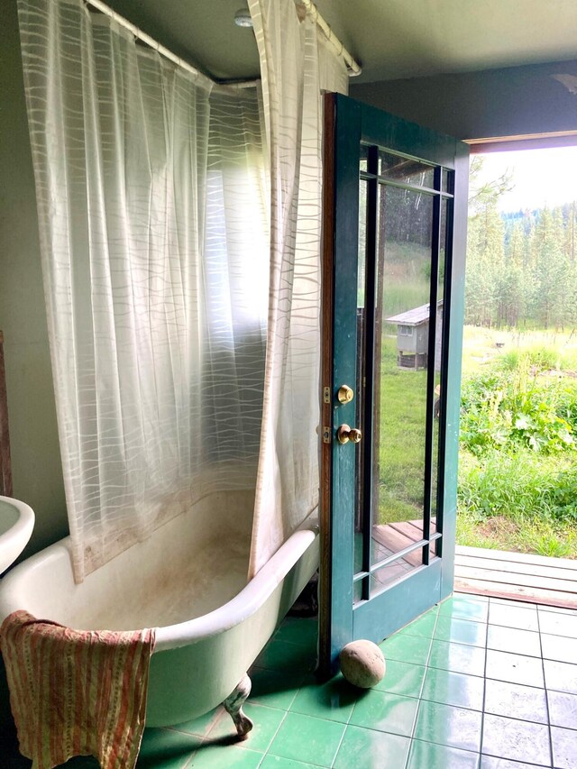 bathroom with a bathing tub and tile patterned floors