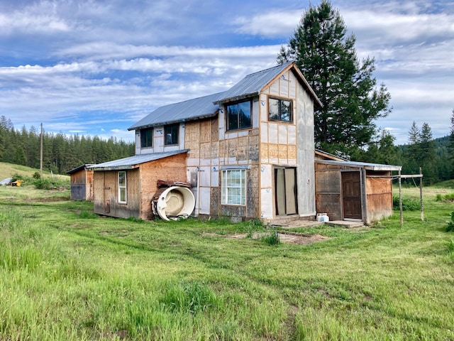 rear view of house with a lawn