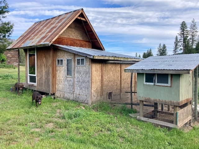 view of home's exterior with an outbuilding