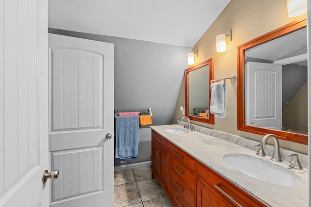 bathroom featuring lofted ceiling, tile patterned flooring, and vanity