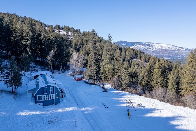 snowy aerial view with a mountain view