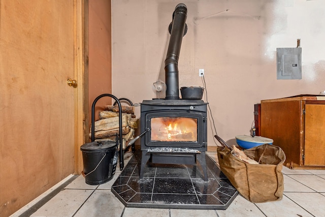 room details with electric panel and a wood stove