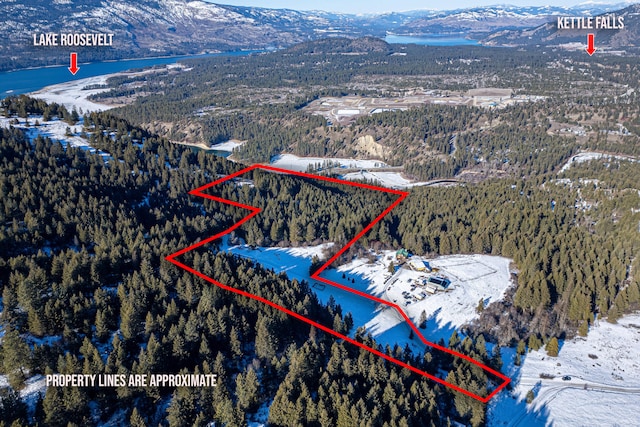 snowy aerial view with a mountain view