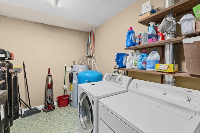 washroom with electric water heater and washing machine and clothes dryer