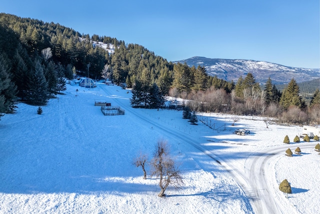 snowy aerial view with a mountain view