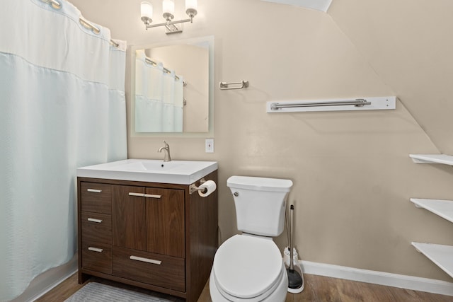 bathroom with hardwood / wood-style floors, vanity, a shower with shower curtain, and toilet