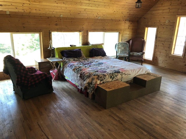 bedroom featuring wood finished floors, lofted ceiling, and wooden walls