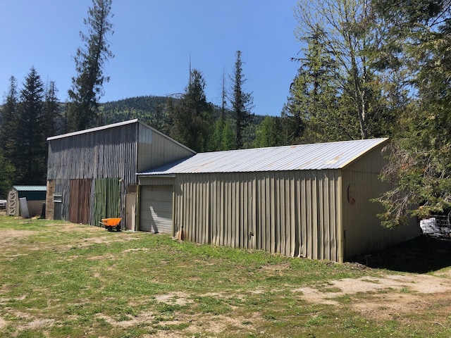 view of pole building with a wooded view