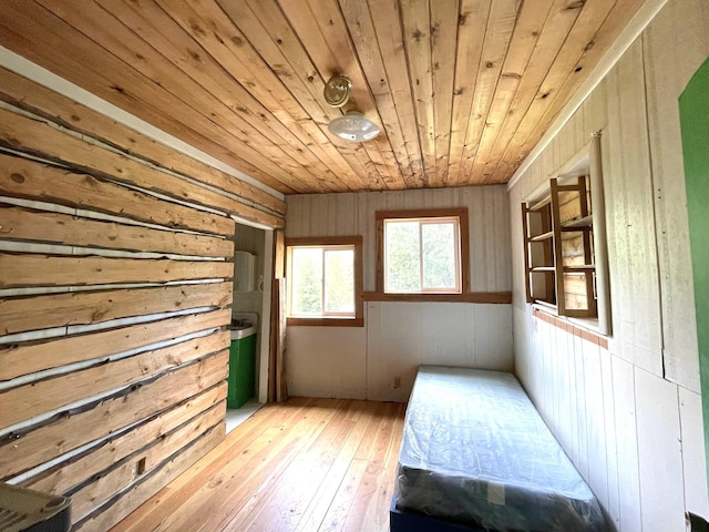 bedroom with wood walls, wooden ceiling, and hardwood / wood-style floors