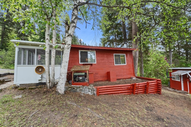 view of outbuilding with an outdoor structure and a sunroom