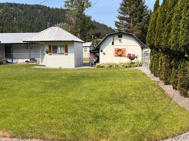 2851 Deep Lake Lopps Rd, Colville, WA 99114 - exterior space with metal roof, a front yard, and a forest view