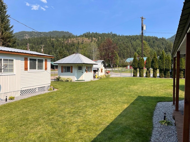 2851 Deep Lake Lopps Rd, Colville, WA 99114 - view of yard with fence, a wooded view, a mountain view, and an outbuilding