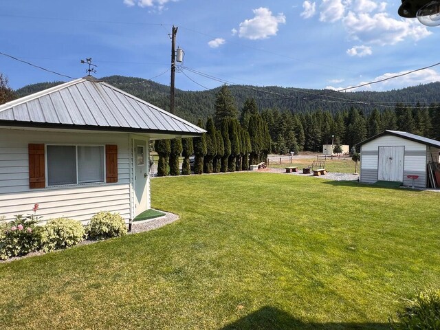 2851 Deep Lake Lopps Rd, Colville, WA 99114 - view of yard with a wooded view, a mountain view, an outdoor structure, and a shed