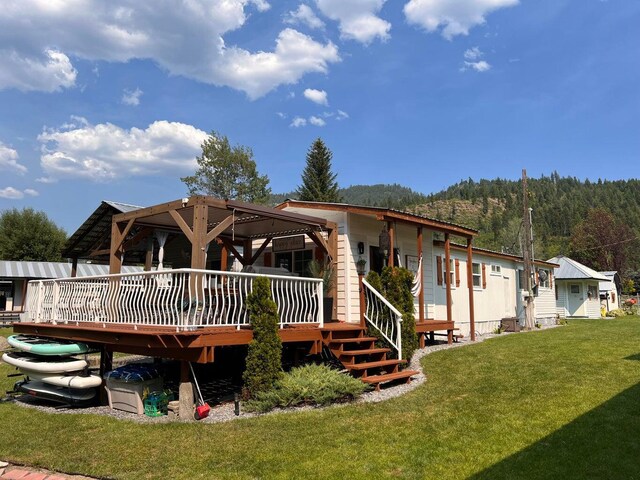 2851 Deep Lake Lopps Rd, Colville, WA 99114 - rear view of property with a wooden deck and a yard