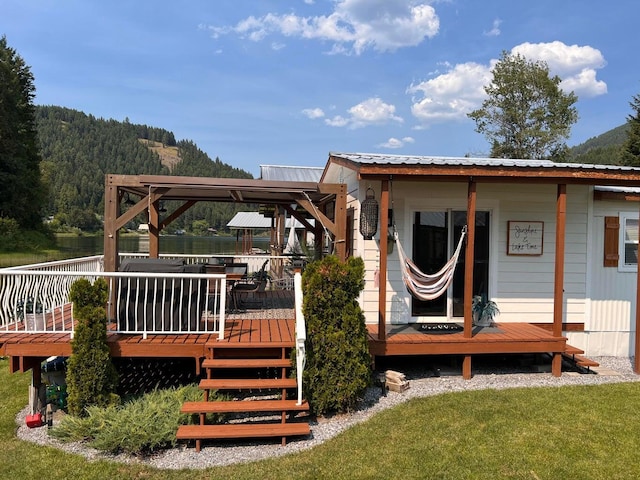 2851 Deep Lake Lopps Rd, Colville, WA 99114 - back of house featuring metal roof, a lawn, and a wooden deck