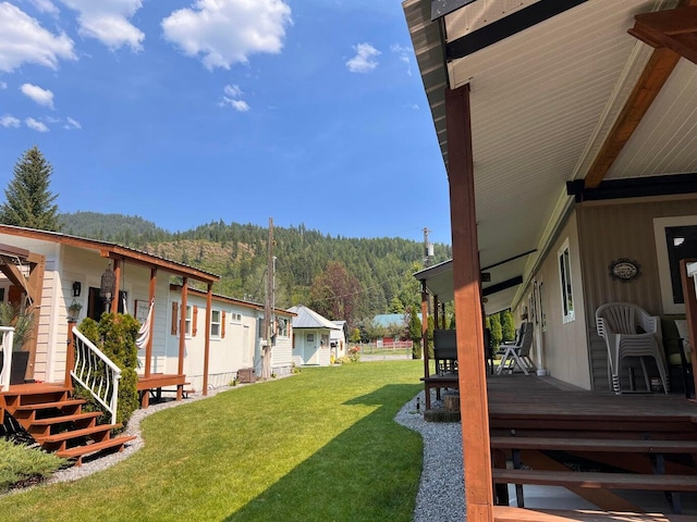 2851 Deep Lake Lopps Rd, Colville, WA 99114 - view of yard with a wooden deck and a forest view