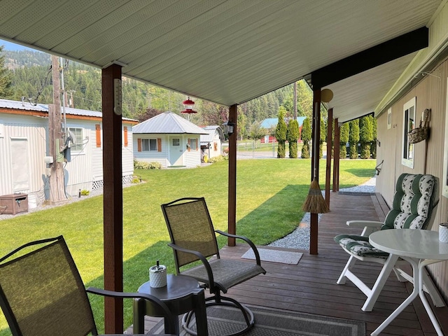 2851 Deep Lake Lopps Rd, Colville, WA 99114 - wooden deck with a lawn and an outbuilding
