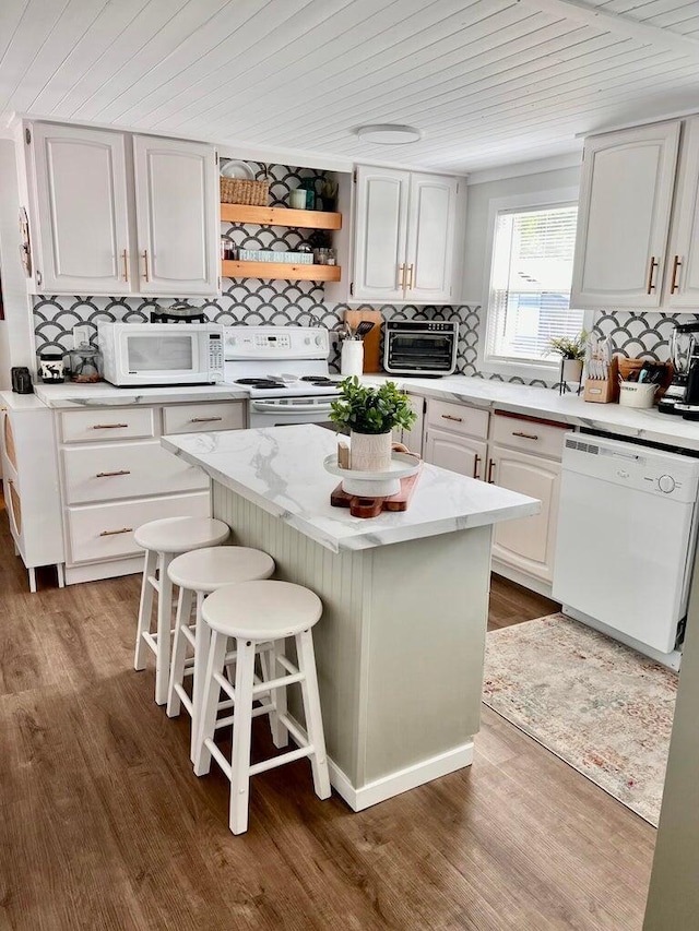2851 Deep Lake Lopps Rd, Colville, WA 99114 - kitchen with wooden ceiling, decorative backsplash, a center island, white appliances, and wood finished floors
