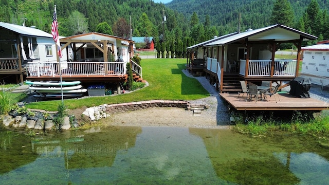 2851 Deep Lake Lopps Rd, Colville, WA 99114 - view of yard featuring a deck and a forest view