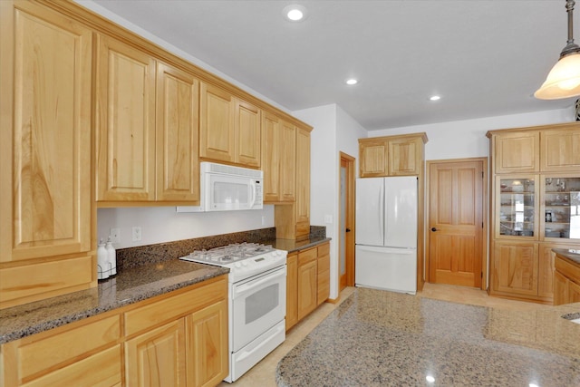 kitchen with pendant lighting, light brown cabinetry, dark stone countertops, recessed lighting, and white appliances
