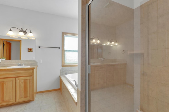full bath with vanity, tile patterned floors, a garden tub, and a stall shower