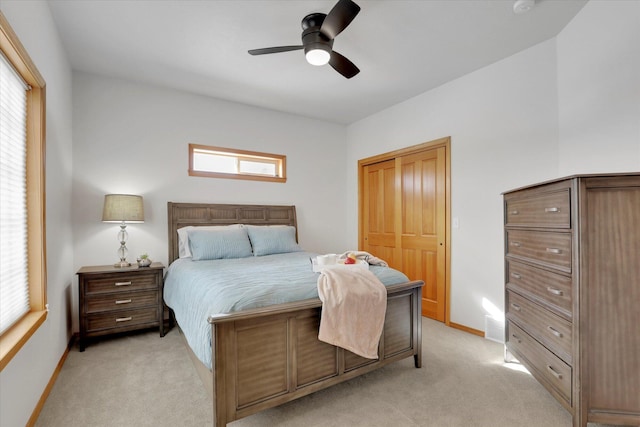 bedroom with light carpet, a ceiling fan, baseboards, visible vents, and a closet