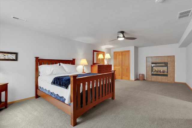 carpeted bedroom with visible vents, a ceiling fan, and baseboards
