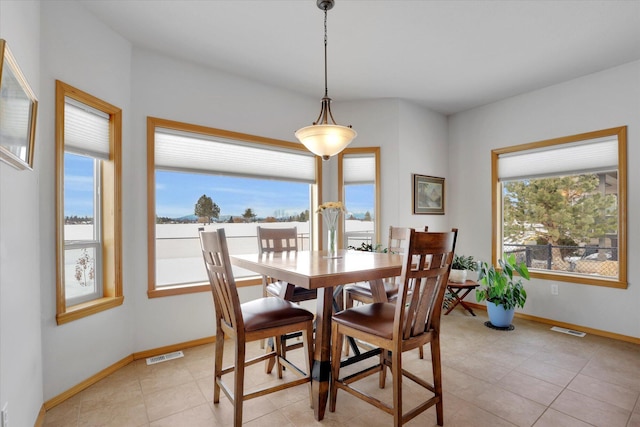 dining area with baseboards, light tile patterned flooring, and visible vents