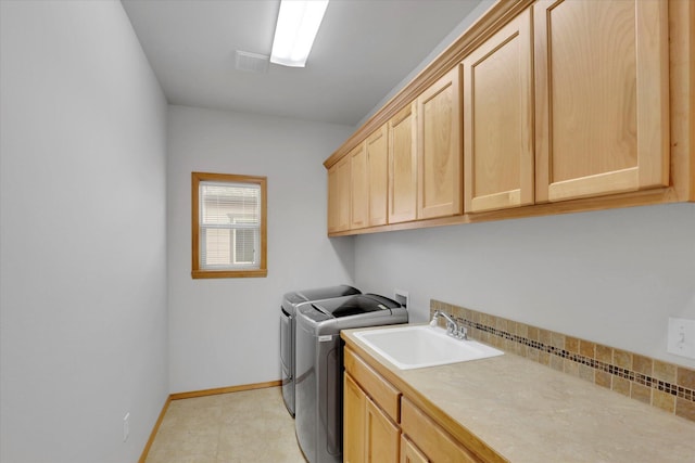 laundry room with visible vents, washer and dryer, baseboards, a sink, and cabinet space
