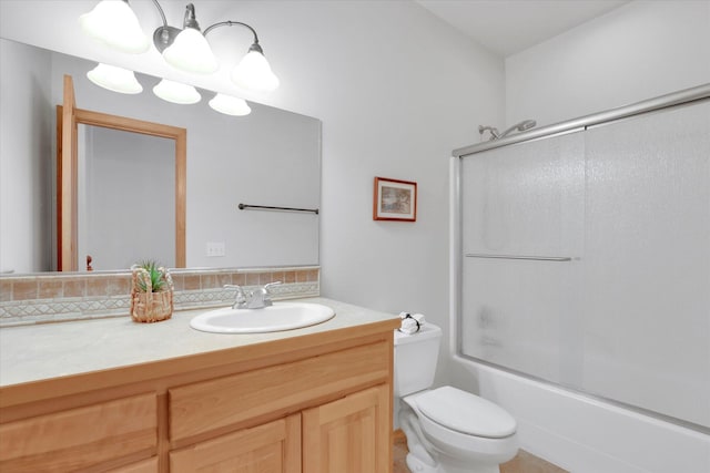 full bath with backsplash, toilet, enclosed tub / shower combo, and vanity