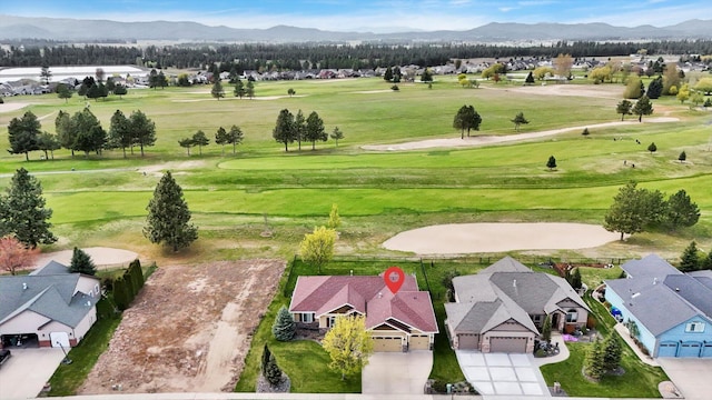 bird's eye view featuring a mountain view, golf course view, and a residential view