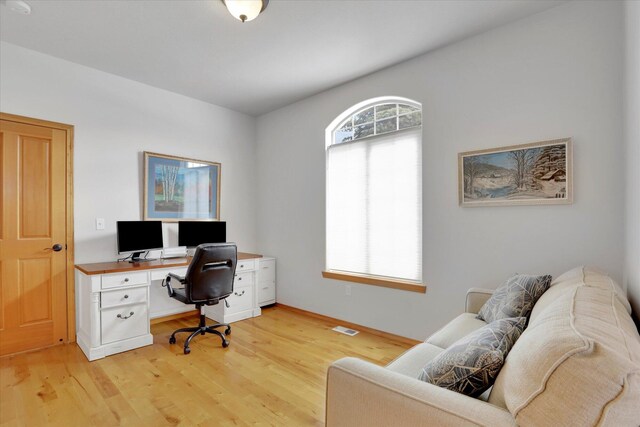 office space with light wood-style floors and visible vents