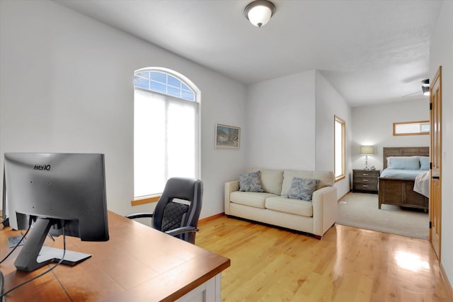 office area with baseboards and light wood-style flooring