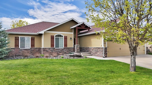 craftsman inspired home featuring a shingled roof, a front lawn, stone siding, a garage, and concrete driveway