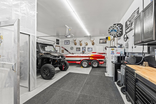 31914 N Zander Ln, Chattaroy, WA 99003 - garage with a workshop area and a garage door opener