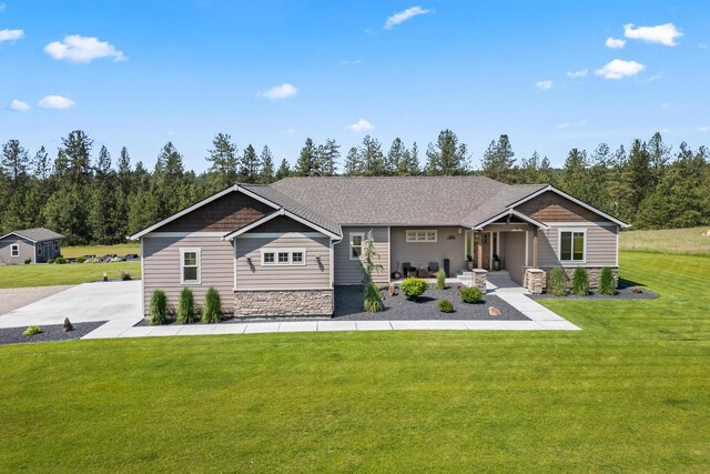 31914 N Zander Ln, Chattaroy, WA 99003 - craftsman inspired home featuring a front lawn, stone siding, and covered porch