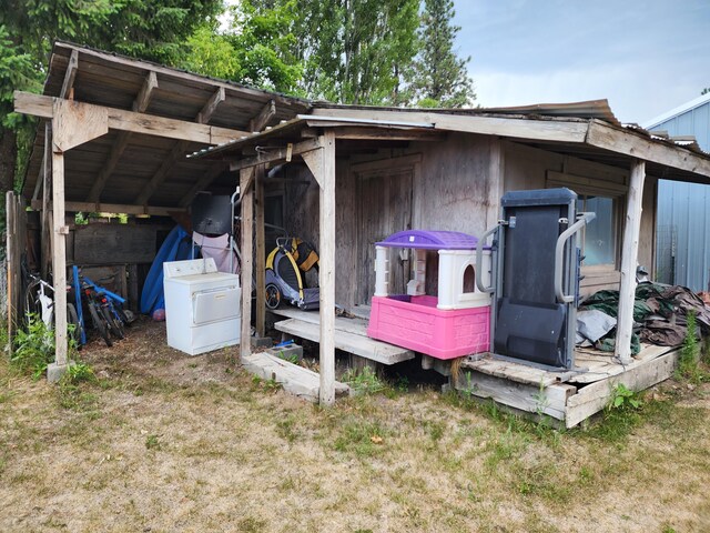 view of outbuilding featuring a lawn