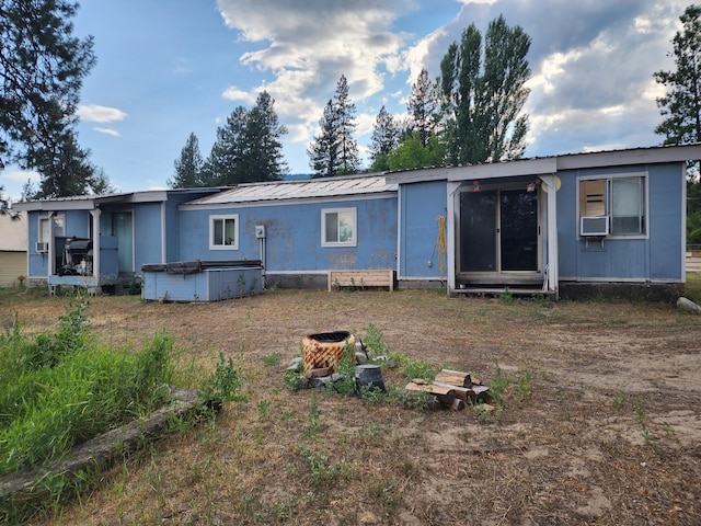 back of house featuring a hot tub