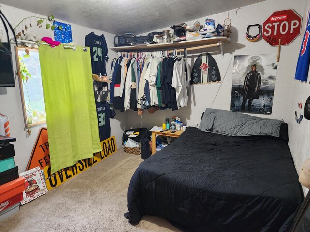 carpeted bedroom featuring a textured ceiling