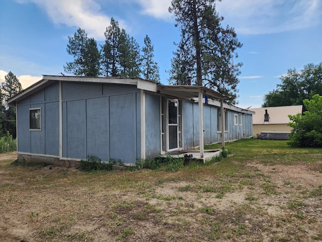 view of side of home featuring a yard