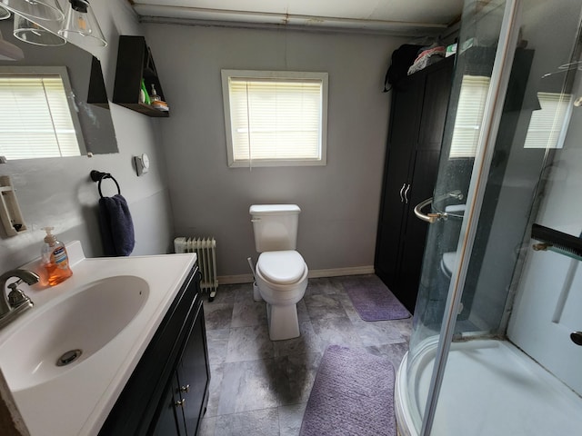 bathroom featuring vanity, walk in shower, radiator, and toilet