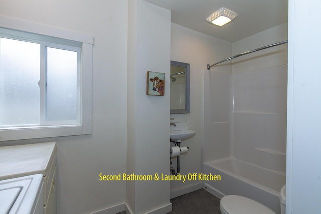 full bathroom featuring vanity, a wealth of natural light,  shower combination, and toilet