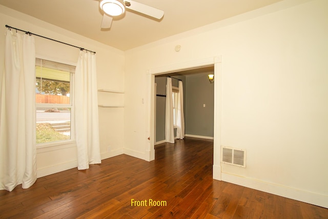 spare room with ceiling fan and dark hardwood / wood-style flooring